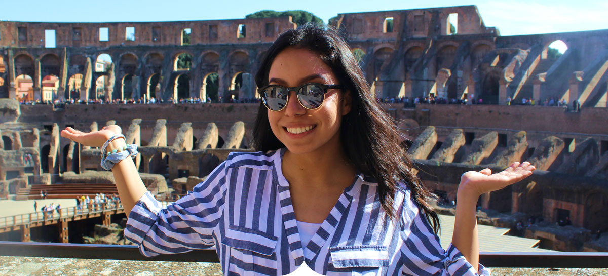 Girl standing in front of the Roman Colosseum